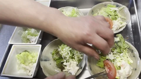Chef Adding Tomato Wedges To Fresh Salad Plates In A Japanese Kitchen Stock-Footage 338320268