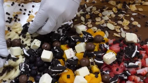 Chef Adding Toppings to Gourmet Chocolate Creep Platter Stock Footage 345692253