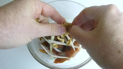 Chef adding walnuts to a salad with dried persimmons and onions Stock Footage 327790889
