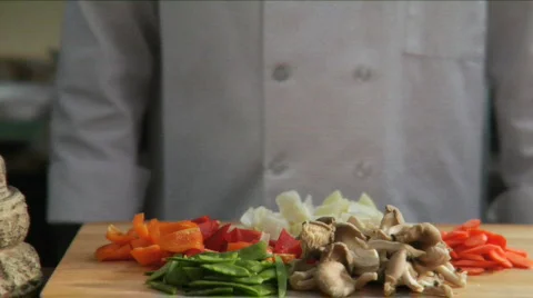 Chef adds Asian vegetables to wok Stock Footage