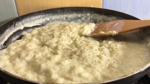 The chef adds black pepper to the bechamel sauce. Video stock 104134590