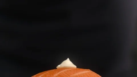 Chef adds caviar to the sushi roll with salmon and rice, making the nigiri in Stock Footage 116541403