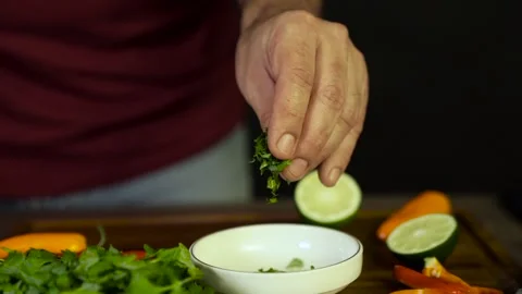 Chef adds Cilantro in the bowl Stock Footage 243604632