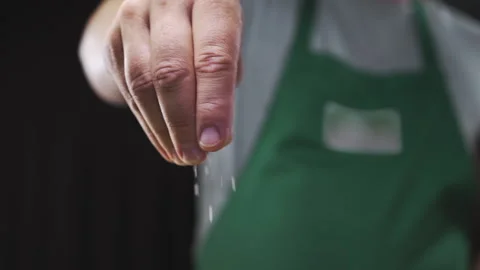 Chef adds coarse salt to the dish cooking in slow motion Stock Footage 143593527