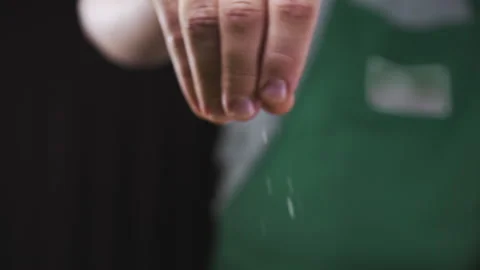 Chef adds coarse salt to the dish cooking in slow motion Stock Footage 143593579