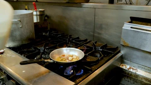 Chef adds cream to pan to create sauce 스톡 동영상 94253229