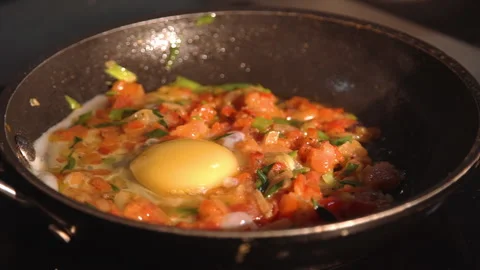 The chef adds eggs to the frying pan with vegetables Stock Footage 158021759