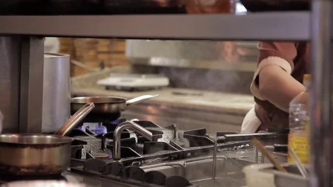 The chef adds flour in frying pan in the kitchen restaurant Stock Footage 75915065