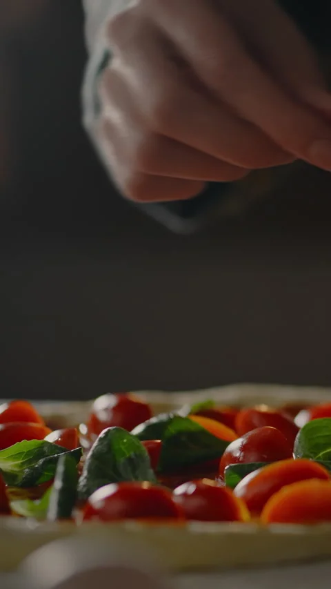 Chef adds fresh basil to mozzarella cheese at an Italian kitchen in a focuse Stock Footage 331536564