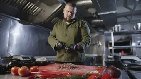 The chef adds the last ingredient to the meat marinade. Stock Footage 233615504