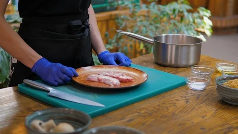 Chef adds pepper to the main ingredient of the dish Stock Footage 119546731