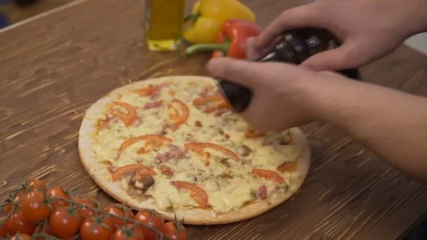 The chef adds pepper on the pizza Stock Footage 71374034