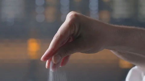 Chef adds salt to the dish, cooking food cook salting food at kitchen Stock Footage 129688314