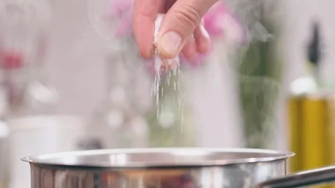 Chef adds salt to the dish, slow motion. Stock-Footage 153480890