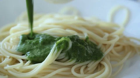 Chef adds sauce to the pasta. Stock Footage 90994244