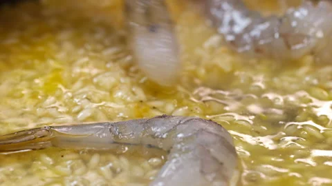 The Chef Adds Shrimp to the Risotto Stock Footage 145650861
