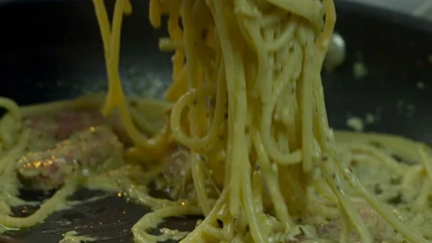 Chef Adds Spaghetti from Frying Pan to Plate Stock Footage 145639591