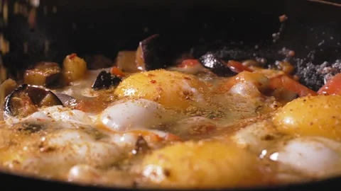 Chef adds spices and red pepper to yolk of eggs Stock Footage 250598651