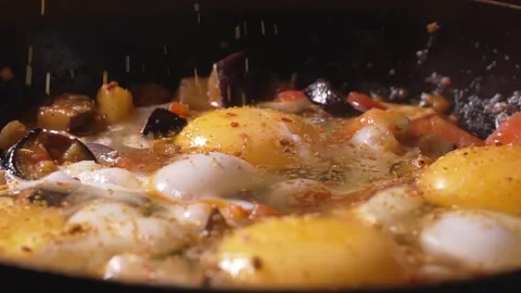 Chef adds spices and red pepper to yolk of eggs 스톡 동영상 250600331