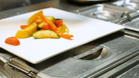 Chef adds steak to plate in kitchen slow motion Video stock 94262354