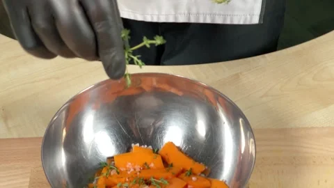 The chef adds thyme leaves to the dish Stock Footage 306803202