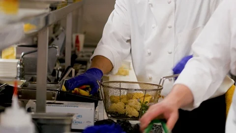 Chef adds vegetables into mesh basket fryer in the professional kitchen Stock-Footage 107342601