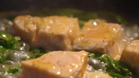 The chef adds wine to the pan with salmon and vegetables Stock Footage 158020201