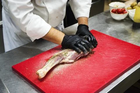 The chef also prepares lamb shank dishes. The process of cooking lamb shank male Stock Photos