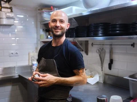 Chef with an alternative look standing on a kitchen of a restaurant Stock Photos