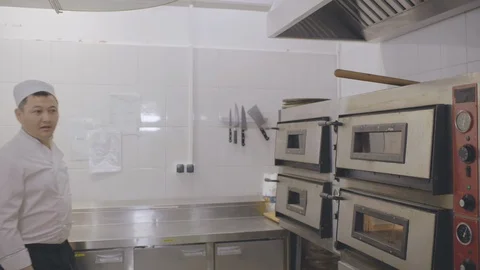 Chef and cook inspecting kitchen cleanliness before workday Stock Footage 125049454