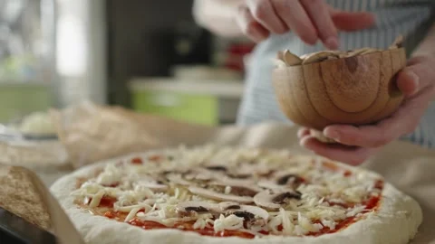 Chef in apron makes pizza with his hands putting the ingredients Stock Footage 280159039