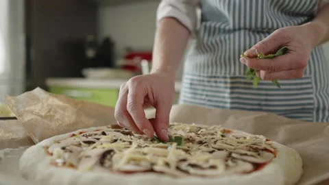 Chef in apron makes pizza with his hands putting the ingredients Stock Footage 280159121