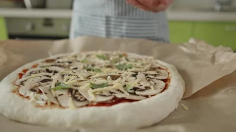 Chef in apron makes pizza with his hands putting the ingredients Stock Footage 280159331