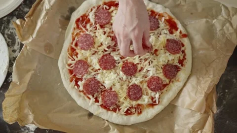 Chef in apron makes pizza with his hands putting the ingredients Stock Footage 280159712