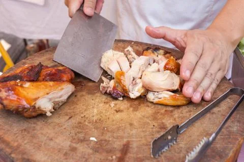 Chef are using Kitchen knife chicken grilled on wood block Stock Photos