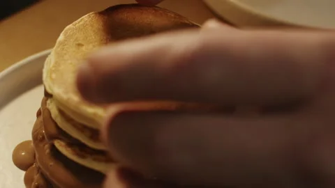 Chef arranges pancake and chocolate mousse dessert on elegant white plate 스톡 동영상 151361955