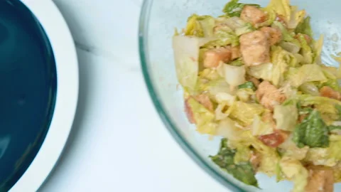 The chef is arranging professionally Caesar Salad in a serving plate in 4K. Stock Footage 140769324