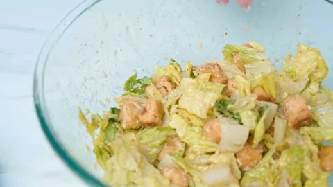 The chef is arranging professionally Caesar Salad in a serving plate in 4K. Stock Footage 140769632