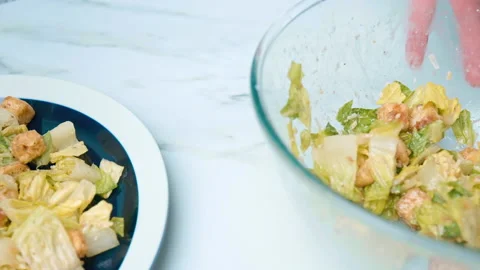 The chef is arranging professionally Caesar Salad in a serving plate in 4K. Stock Footage 140769885