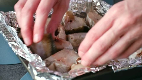 Chef arranging raw fish pieces for baking Video stock 337549593