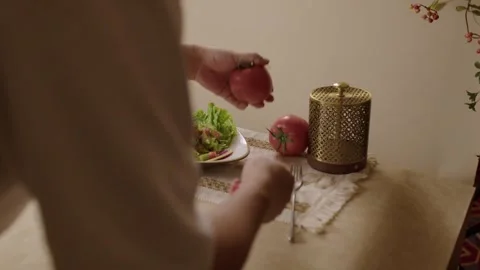 Chef arranging tomatoes and salad on a traditional middle eastern dinner table 動画素材 345134334
