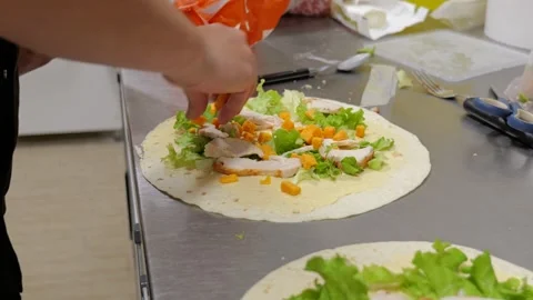 Chef Assembling Chicken and Cheese Wrap in Kitchen Vidéo 336416183