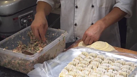 Chef Assembling Dumplings in a Singapore Restaurant Stock Footage 77919994