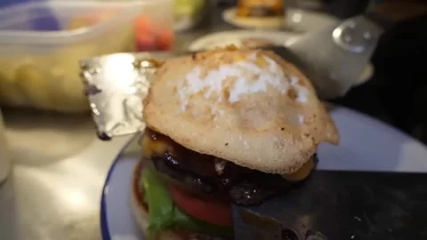 Chef Assembling Gourmet Cheeseburger with Crispy Fried Egg Stock-Footage 347687725