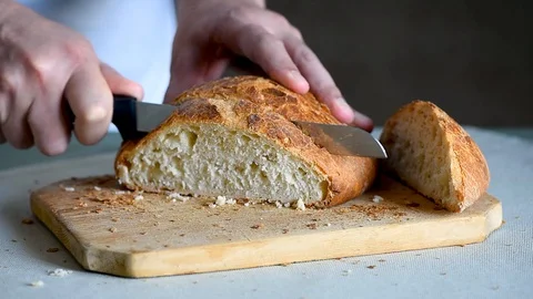 Chef baker cuts fresh italian bread Stock Footage 129512331