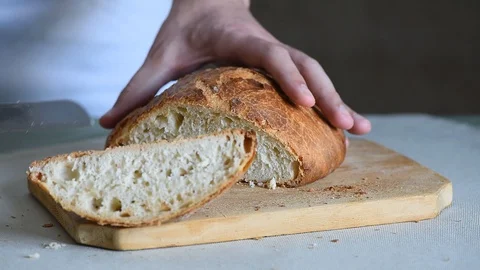 Chef baker cuts fresh italian bread Stock Footage 129512336