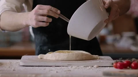 Chef baker making pie at home in the kitchen, adds egg white to baked goods Stock Footage 266996316