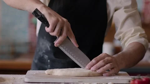 Chef baker making a pie in the kitchen of a house close up, cutting the dough Stock-Footage 266982897