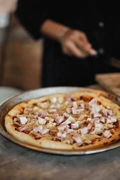 Chef baker making pizza at kitchen. Stock Photos