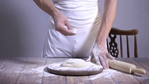 Chef. Baker. Sprinkle with flour dough. making pasta, pizza Stock Footage 90220456
